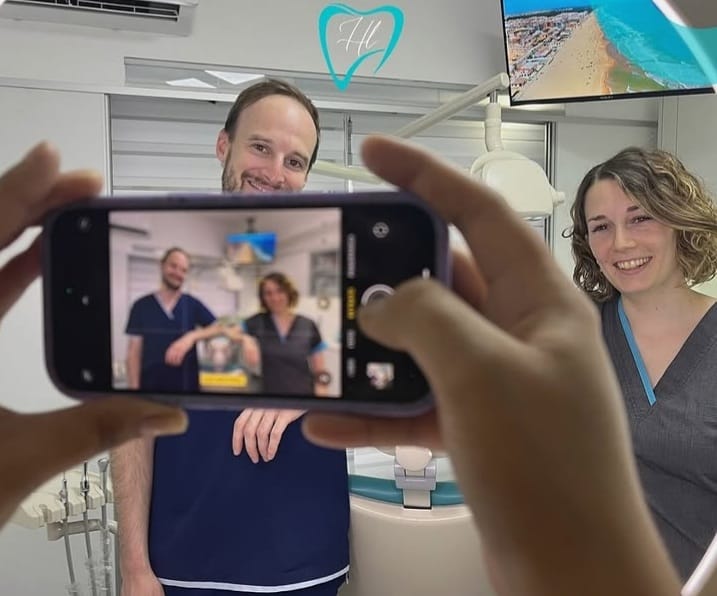 Profesionales de la odontología en un consultorio, fotografiados a través de un teléfono